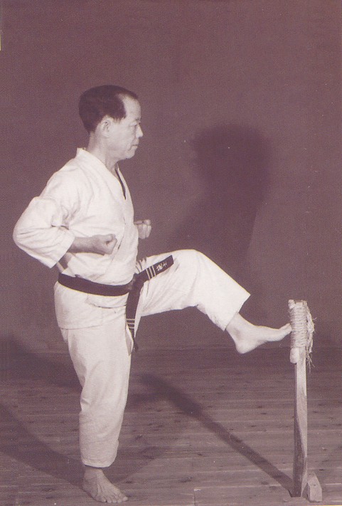 Osensei Nagamine practising kicks on makiwara